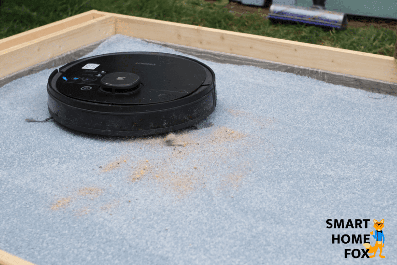 The Deebot OZMO 950 during the sand vacuum review on a long fiber carpet.